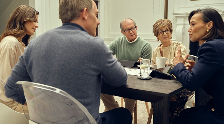 A family meeting with an advisor in a conference room.