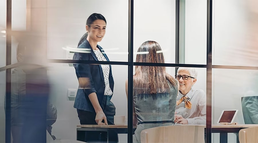 Workers in a meeting in a conference room.