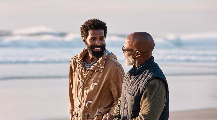 A Picture of a Father and Son Walking on the Beach