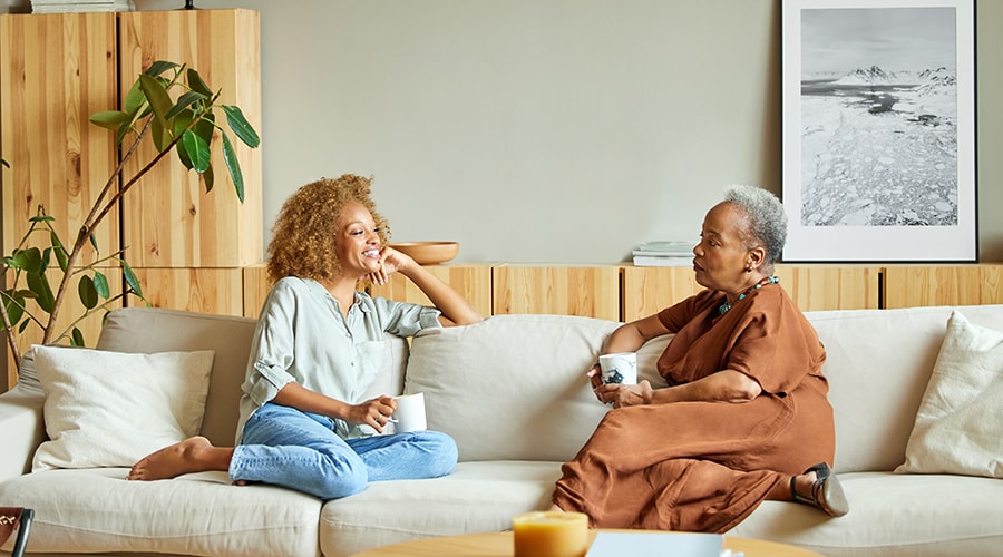 Man and woman talking in a corporate dining hall.