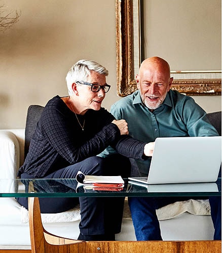 Older man and woman looking at laptop.