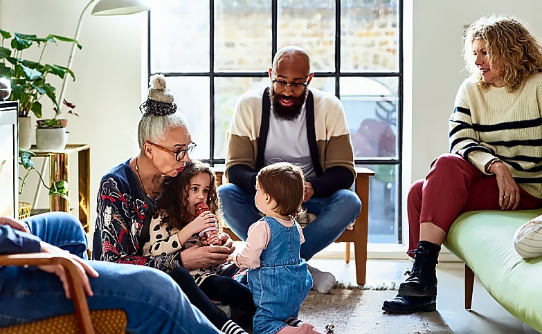 Multi-generational, multi-ethnic family in a living room.