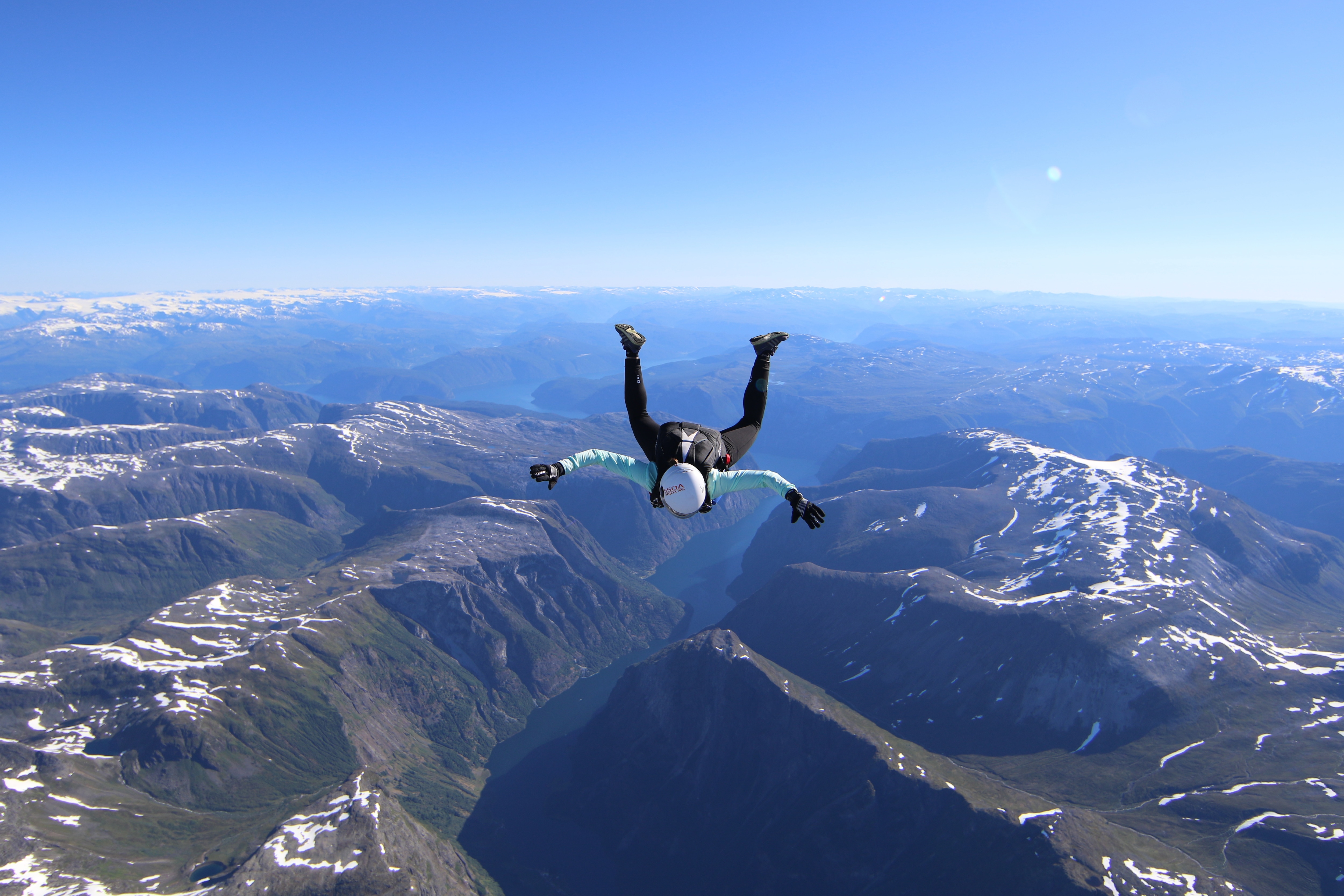 Skydiver falling between mountain range