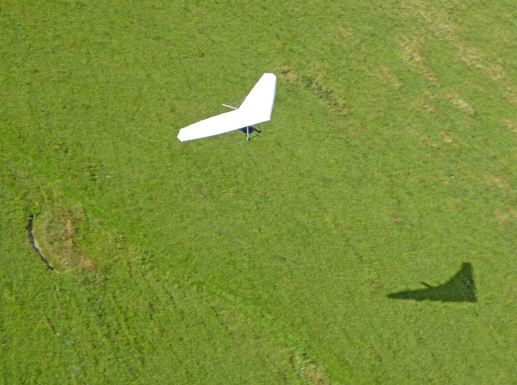 Hang glider and its shadow