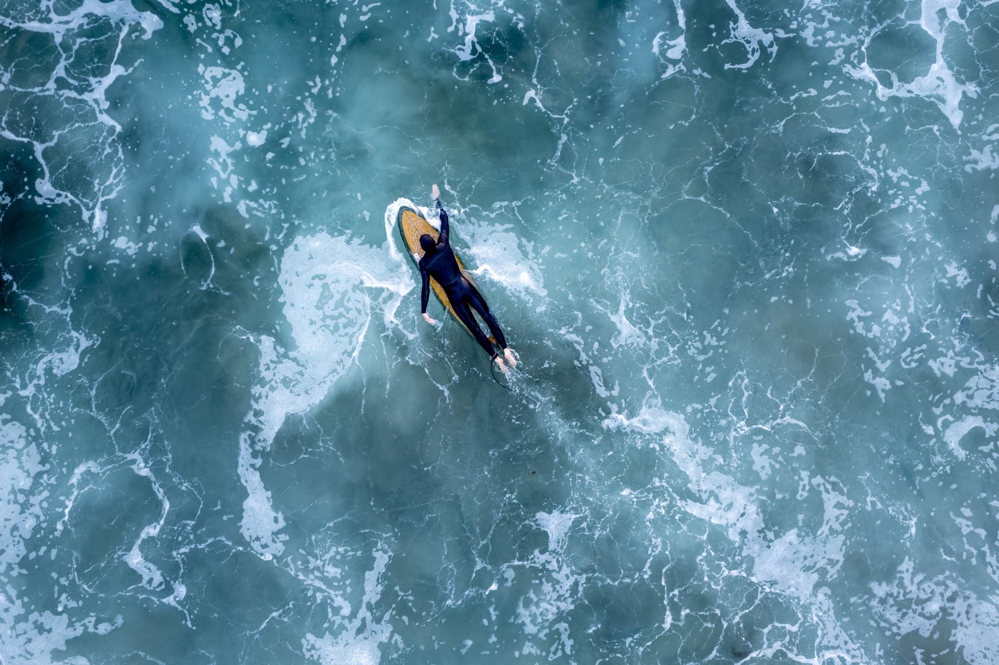 surfer navigates rough waters on surf board