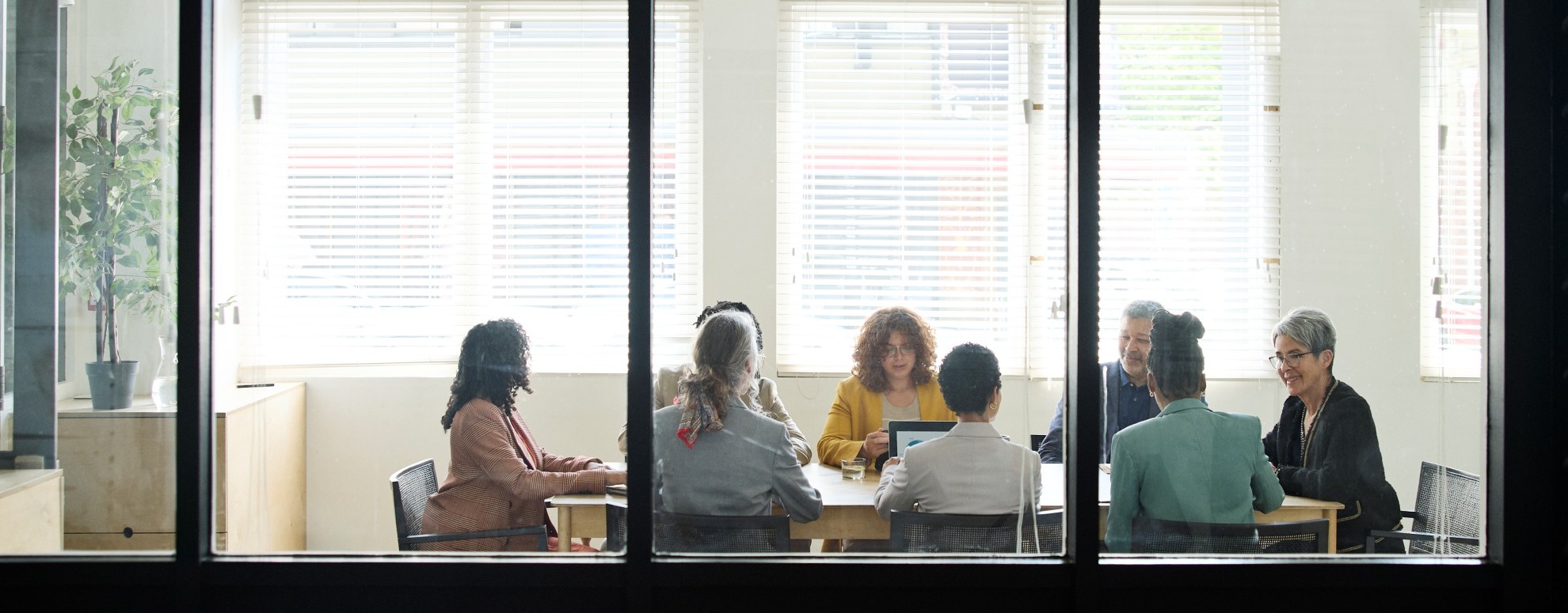 Coworkers sitting around conference table in urban office