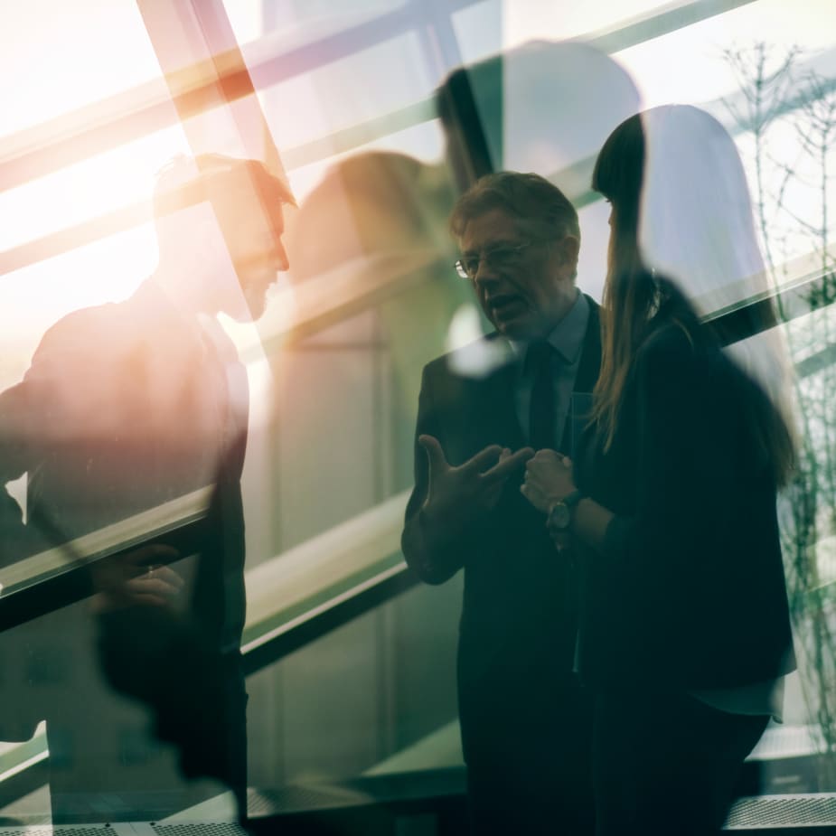 group of three people talking