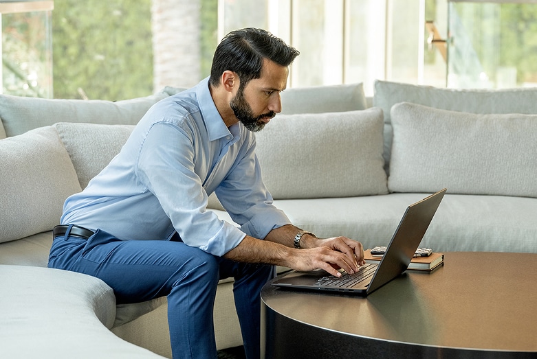 Man reading report on laptop