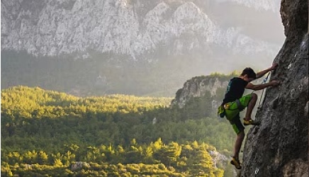 Rock climber scaling a cliff.